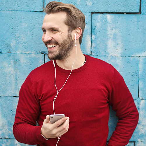 Man on the phone smiling.