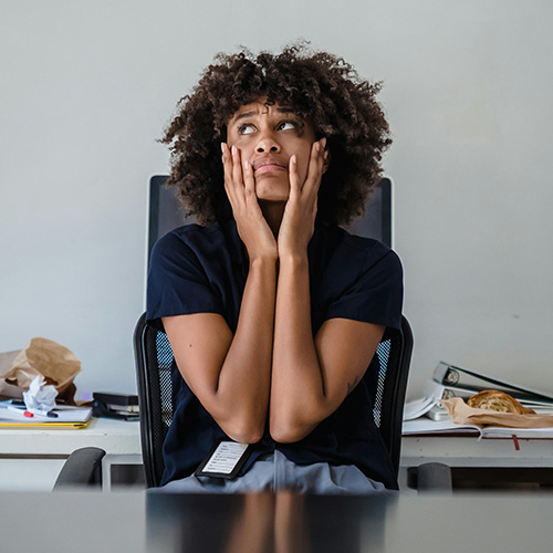Young lady looking stressed with hand on her face